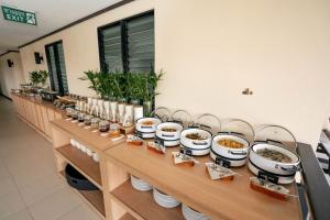 a buffet with bowls of food on a table at Ratana Hotel Chalong in Rawai Beach