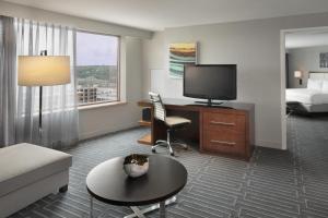 a hotel room with a bed and a television at Hyatt Regency Cincinnati in Cincinnati
