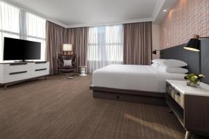 a hotel room with a bed and a flat screen tv at Hyatt Centric Downtown Minneapolis in Minneapolis +77 photos