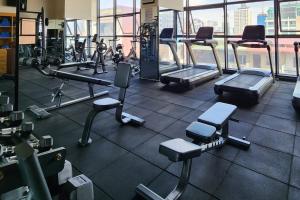 a gym with treadmills and machines in a building at Ramada by Wyndham Phnom Penh Central in Phnom Penh +21 photos