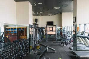 a gym with a lot of treadmills and machines at Ramada by Wyndham Phnom Penh Central in Phnom Penh