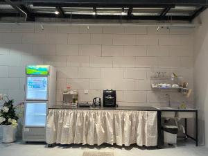 a kitchen with a counter top and a refrigerator at Phieu Brew Homestay in Hà Tiên