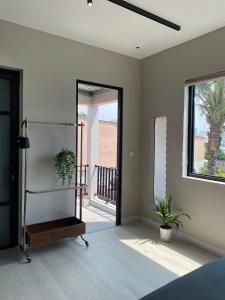 a room with a bedroom with a mirror and a balcony at Phieu Brew Homestay in Hà Tiên