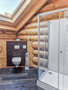 a bathroom with a toilet and a wooden wall at Ferienblockhaus Schwarzwald - Luxus Chalet mit Sauna & Whirlpool in Feldberg +25 photos