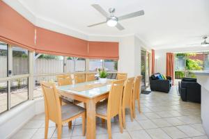 a dining room with a table and chairs at 2 Marto Court in Normanville