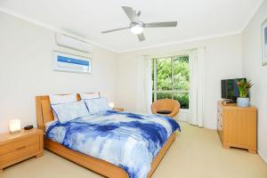 a bedroom with a bed and a ceiling fan at 2 Marto Court in Normanville