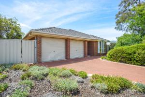 a brick house with a garage at 2 Marto Court in Normanville