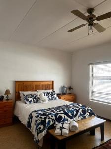 a bedroom with a bed and a ceiling fan at Casa Bella in Dwarskersbos