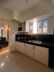 a kitchen with white cabinets and a sink at 2-Storey with 4BR Villa in a High-End Subdivision in Davao City