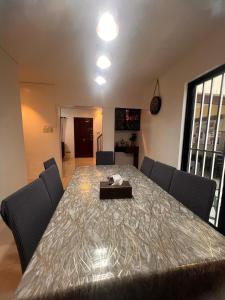 a dining room with a table with chairs and a tableablish at 2-Storey with 4BR Villa in a High-End Subdivision in Davao City