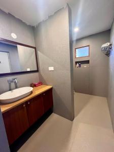 a bathroom with a sink and a mirror at Krsna Farm Villa in Bangalore +15 photos