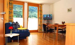 a living room with a blue couch and a table at Haus Blankus in Brand