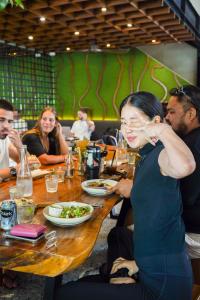 a group of people sitting at a table eating food at Sokkool Coliving and Coworking - Near Berawa Beach in Canggu +66 photos