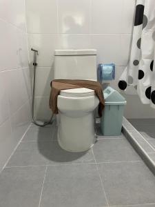 a bathroom with a toilet with a towel on it at Butterfly Home Mai Khao Phuket in Ban Suan Maphrao +3 photos