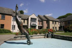 a statue of a girl in front of a building at Brennan Court Guest Accommodation in Limerick