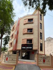 a building with a sign that reads the hotel at Hotel The Hood in Nagpur