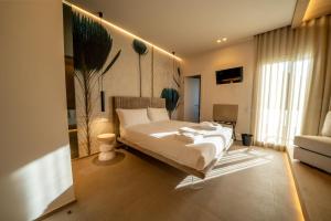 a bedroom with a large bed in a room at Agorà Luxury Experience in Zafferana Etnea