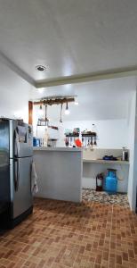 a kitchen with a counter and a refrigerator in it at John and Novy's beach bungalows in San Francisco