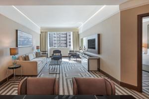 a living room with a couch and a table at Al Maha Arjaan by Rotana in Abu Dhabi