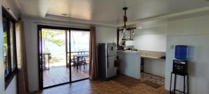 a kitchen with a refrigerator and a kitchen with a balcony at John and Novy's beach bungalows in San Francisco