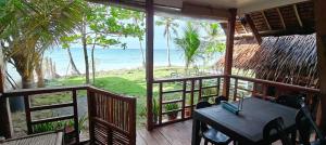 a porch with a table and a view of the ocean at John and Novy's beach bungalows in San Francisco