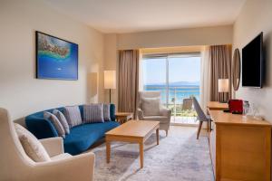 a living room with a couch and a table at Radisson Blu Resort & Spa Cesme in Çeşme