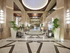 a lobby with a fountain in the middle of a building at Hilton Suites Jabal Omar Makkah in Mecca +84 photos