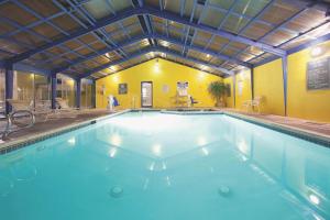 a large swimming pool in a building at La Quinta Inn by Wyndham Salt Lake City Midvale in Midvale +1 photo