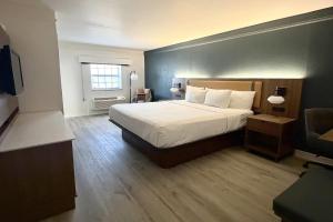 a hotel room with a bed and a window at La Quinta Inn by Wyndham Salt Lake City Midvale in Midvale