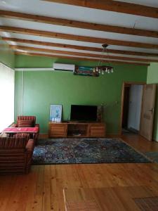 a living room with a couch and a flat screen tv at Sam guest house in Jajce