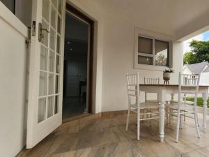 a dining room with a table and chairs at Mia Nina in Heatherlands +2 photos