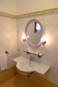 a bathroom with a sink and a mirror at Agriturismo Tenuta Cantagallo in Montelupo Fiorentino