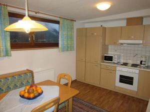 a kitchen with a table with a bowl of fruit on it at Gasthof Waldrast in Zell am Ziller