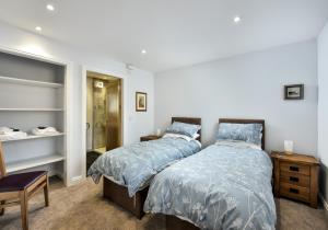 a bedroom with two beds and a walk in closet at The Studio at Pitmeadow Farm in Dunning
