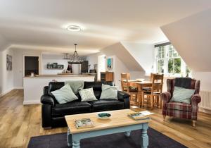 a living room with a couch and a table at The Studio at Pitmeadow Farm in Dunning