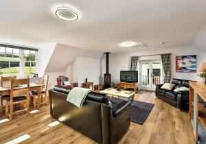 a living room with a couch and a table at The Studio at Pitmeadow Farm in Dunning