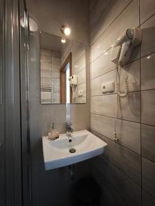 a bathroom with a sink and a mirror at Alda Gold in Pyrzowice +47 photos