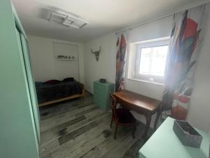 a bedroom with a desk and a bed and a window at OK-City in Bayreuth