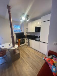 a kitchen with white cabinets and a table in a room at OK-City in Bayreuth