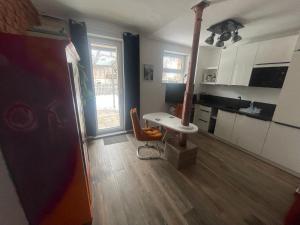 a room with a kitchen with a table and a desk at OK-City in Bayreuth +15 photos