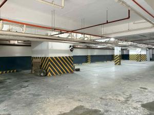 an empty parking garage with a large room with yellow and blue stripes at Palette Cebu The Almonds Boutique Aparthotel Near University of Cebu in Cebu City