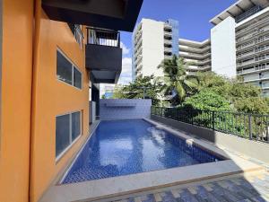 a swimming pool on the side of a building at Palette Cebu The Almonds Boutique Aparthotel Near University of Cebu in Cebu City