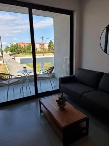 a living room with a couch and a table at JD Studios Kalithea in Kallithea Halkidikis