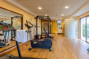 a gym with treadmills and exercise equipment in a room at Villa Nobleza, oasis con piscina y gimnasio a 2 min del centro in El Port de la Selva
