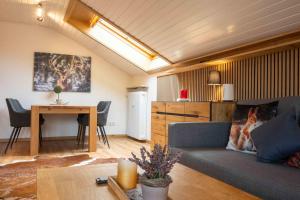 a living room with a couch and a table at Ferienwohnung Allgäu-Hilaria in Fischen