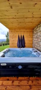 a jacuzzi tub with two umbrellas in a building at Samiro Private Villa - Heated Pool & Hot tub in Áyios Míron