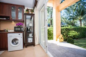 a laundry room with a washer and dryer in a house at Windy Villa by Utalay Koh Chang in Ban Khlong Son