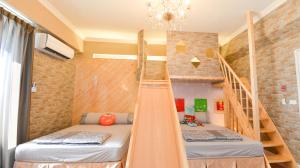a room with two bunk beds and a staircase at Minsuku B&B in Taitung City