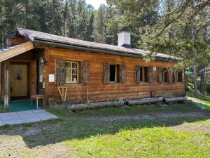 a log cabin in the woods with a porch at Bergunterkunft Ova Spin in Zernez