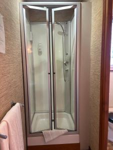 a glass shower in a bathroom with a towel at Hôtel l'Annexe in Moux-en-Morvan +46 photos